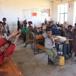 Madmen12-kids-waving-classroom
